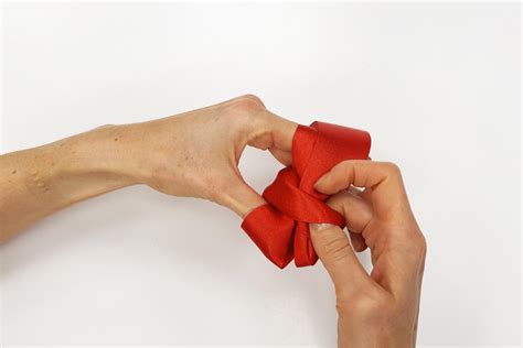 Ilustrácia postupu viazania mašle na prstoch ruky