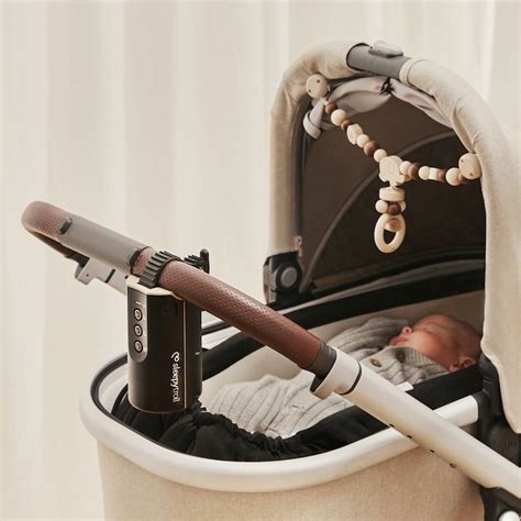 Ilustrácia zariadenia Sleepytroll pripevneného na rukoväť kočíka