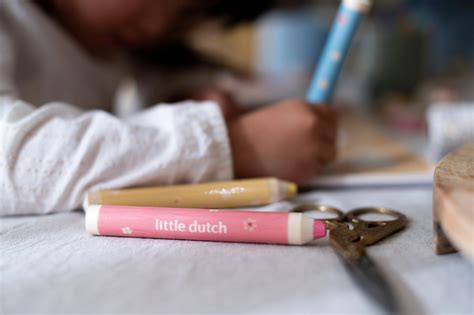 Ilustrácia dieťaťa hrajúceho sa s pastelkami a omaľovánkami.