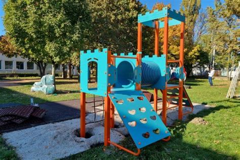 Deti sa hrajú na záhrade materskej školy s trampolínou.