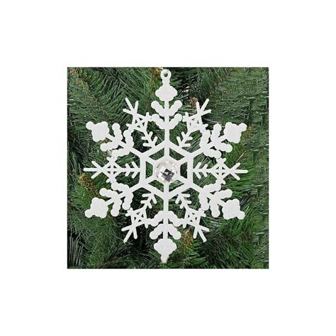 Koláž obrázkov symbolizujúcich december: snehové vločky, vianočné ozdoby, darčeky, astrológické symboly Strelca a Kozorožca